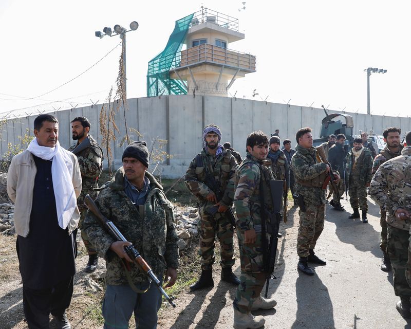 Afghan security forces arrive near the site of a suicide attack in Bagram, north of Kabul, Afghanistan