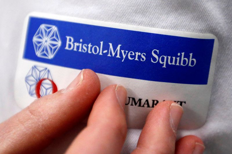 Logo of global biopharmaceutical company Bristol-Myers Squibb is pictured on the blouse of an employee in Le Passage