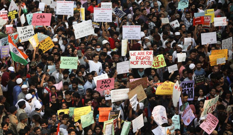 FILE PHOTO: Demonstrators shout slogans and hold placards as they arrive at the venue of a protest against a new citizenship law in Mumbai
