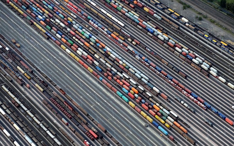 FILE PHOTO: Containers and cars are loaded on freight trains at the railroad shunting yard in Maschen near Hamburg