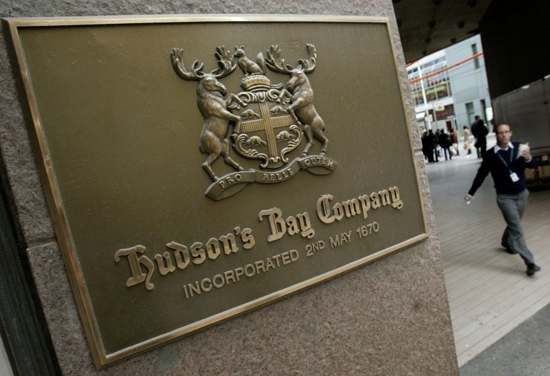 FILE PHOTO: Pedestrian walks past a Hudson's Bay company sign at the retailer's flagship Toronto store