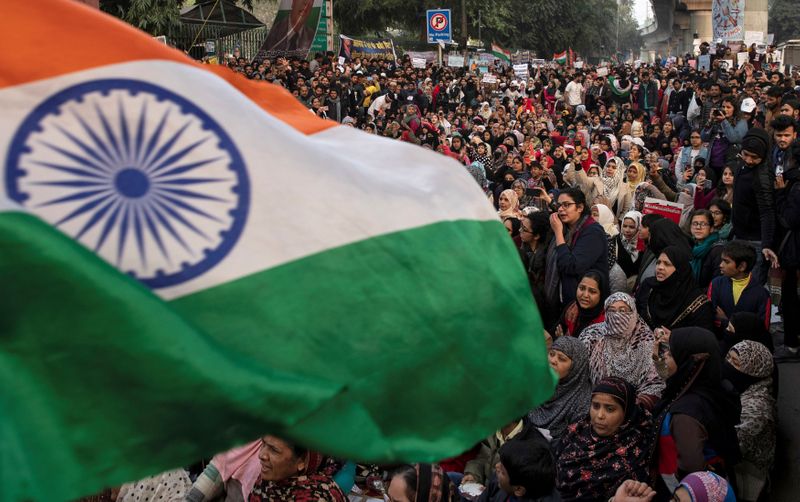 Demonstrators attend a protest against a new citizenship law, outside the Jamia Millia Islamia university in New Delhi