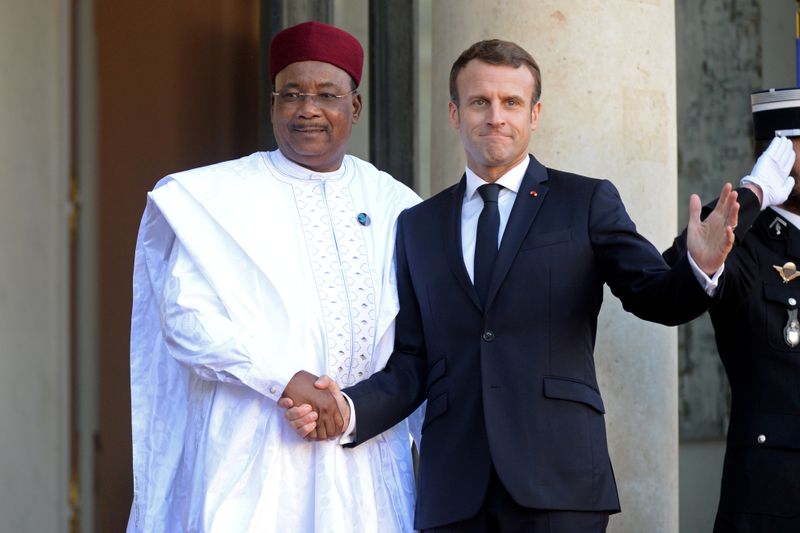 French President Emmanuel Macron weclomes Niger's President Mahamadou Issoufou as he arrives for a lunch at the Elysee Palace as part of the Paris Peace Summit in Paris