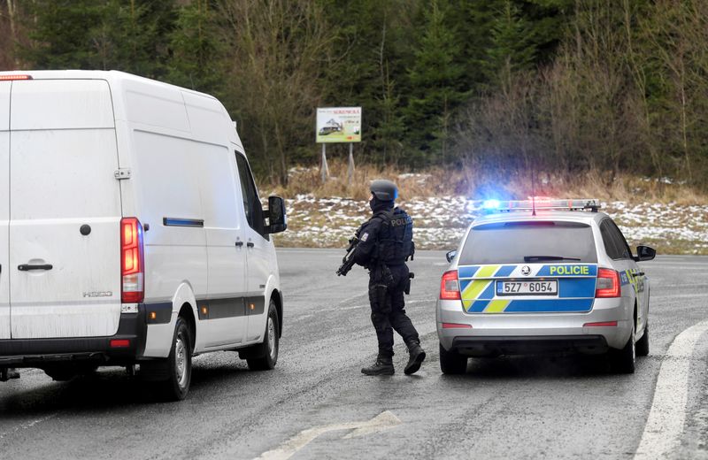 A police officer is seen at a road blockade, as police checks cars after a shooting at Ostrava's University Hospital, near the Slovak-Czech border crossing in Bila