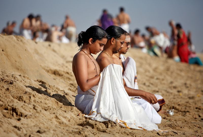 People pray during a prayer ceremony for the victims of the 2004 tsunami on the 15th anniversary of the disaster, in Chennai