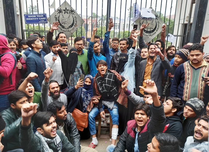 Demonstrators shout slogans during a protest outside a gate of the Jamia Millia Islamia university in New Delhi