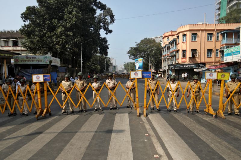 Police stand guard during a protest rally against a new citizenship law, in Mumbai