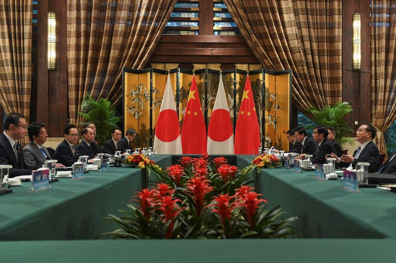 China's Premier Li Keqiang meets with Japan's Prime Minister Shinzo Abe at a bilateral meeting during the 8th trilateral leaders' meeting between China, South Korea and Japan in Dujiangyan