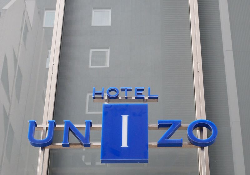 FILE PHOTO: The logo of Hotel Unizo, operated by Japanese hotel operator Unizo Holdings, is seen at the entrance of the hotel in Tokyo, Japan