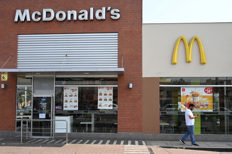 A person walks next to a closed McDonald's restaurant, one of all 29 locations that were closed following the deaths of two teenaged employees, in Lima