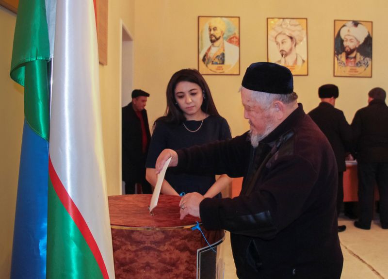 A man casts his ballot during parliamentary election in Tashkent,
