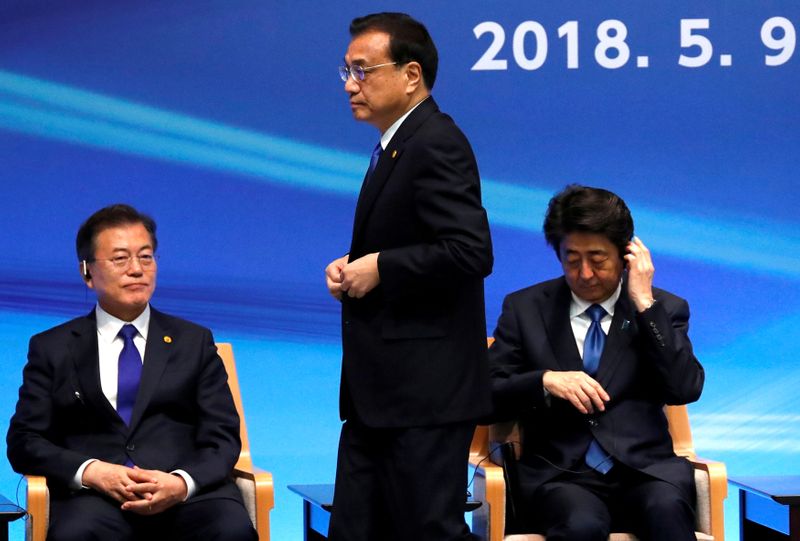 FILE PHOTO: Japan's Prime Minister Shinzo Abe, South Korea's President Moon Jae-in and China's Premier Li Keqiang attend the 6th JAPAN-CHINA-KOREA Business Summit in Tokyo