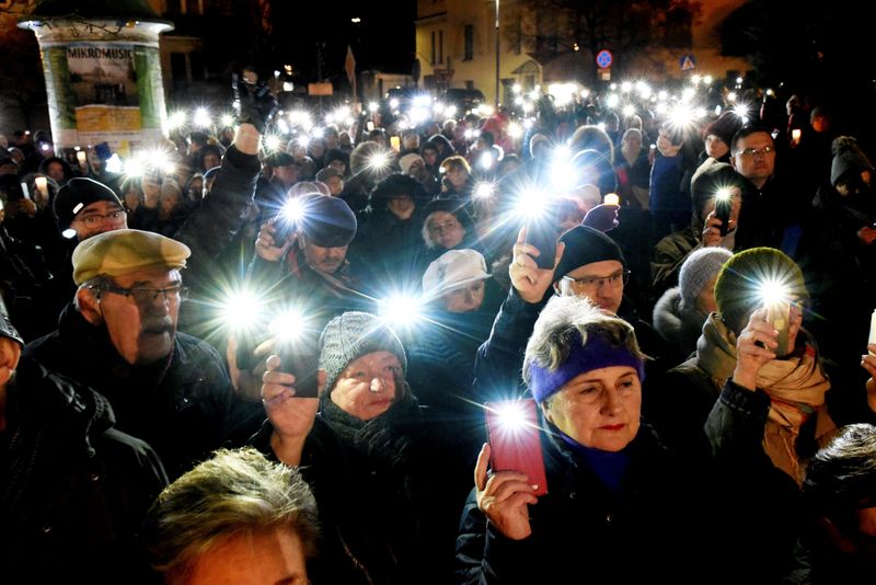 People take part in an anti-government protest in support of free judiciary in Olsztyn