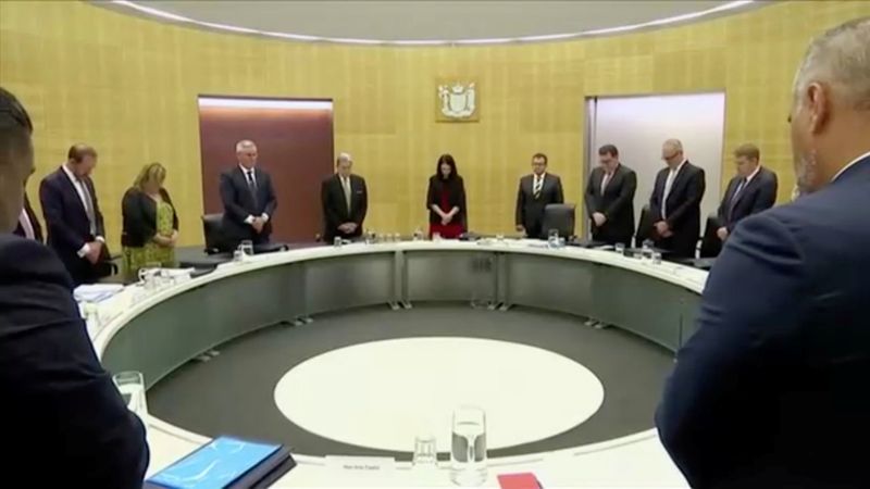 New Zealand's Prime Minister Ardern and fellow politicians observe a minute of silence to mark one week since the deadly eruption of White Island