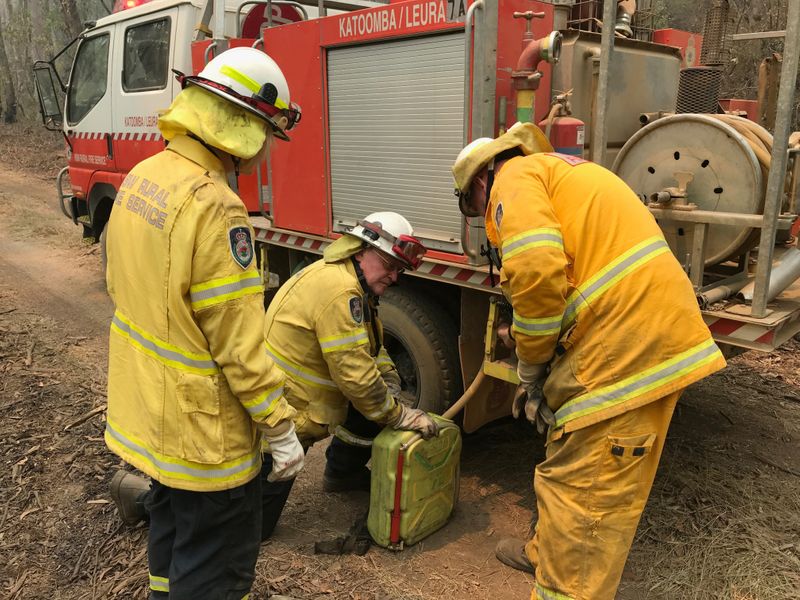 Volunteers from the New South Wales Rural Fire Service work to extinguish spot fires following back burning operations in Australia’s Blue Mountains