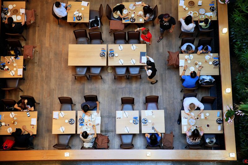 People dine in a restaurant at a mall in Singapore