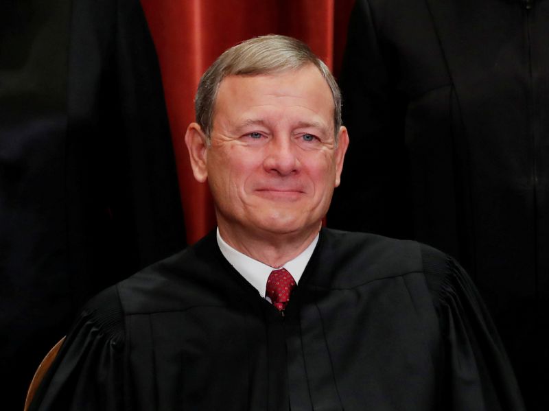 FILE PHOTO: U.S. Supreme Court Chief Justice John Roberts poses during group portrait at the Supreme Court in Washington