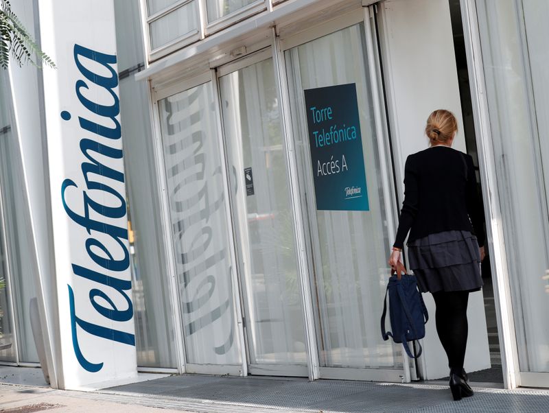 FILE PHOTO: A woman walks into a Telefonica office building in Barcelona