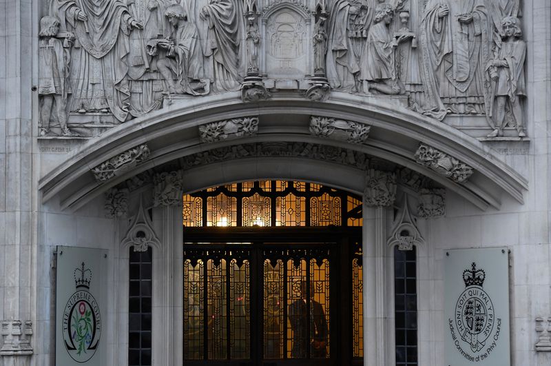 FILE PHOTO: A member of security stands guard inside the Supreme Court in London