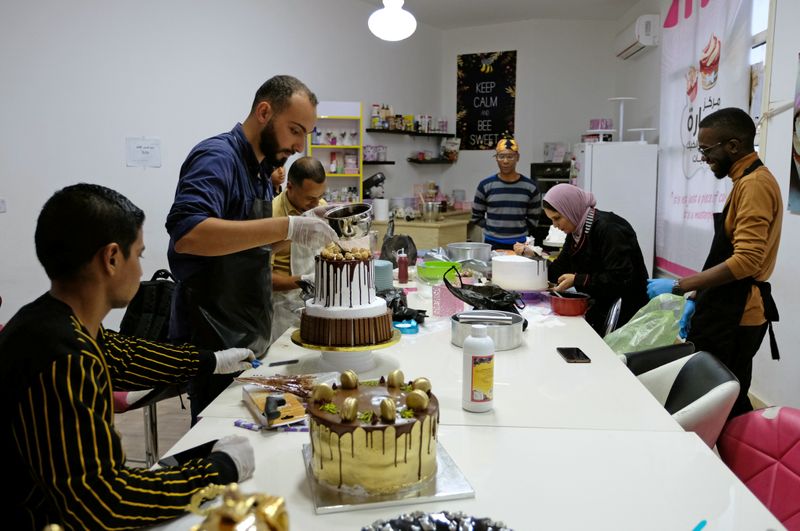 Young people learn how to prepare cakes and sweets at Sarah Center for Sweets in Benghazi