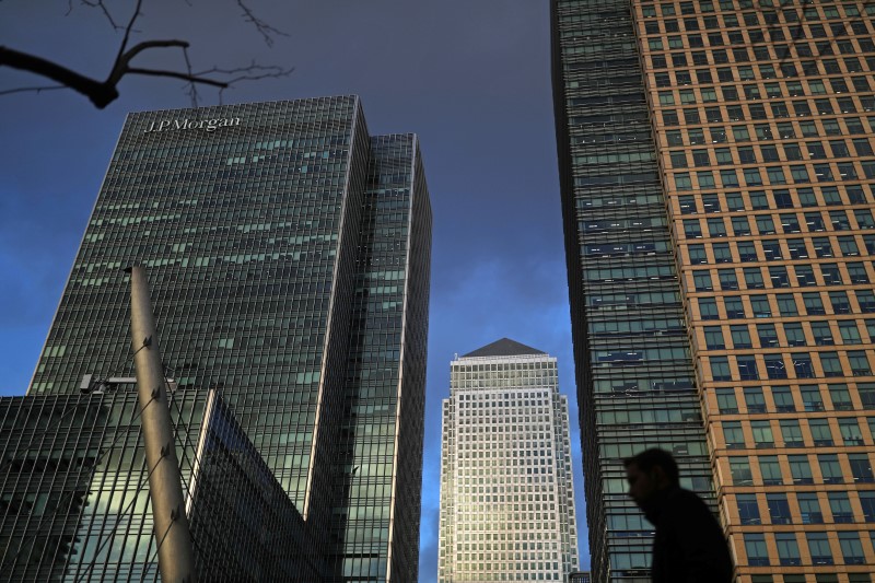 A person walks through the Canary Wharf financial district of London