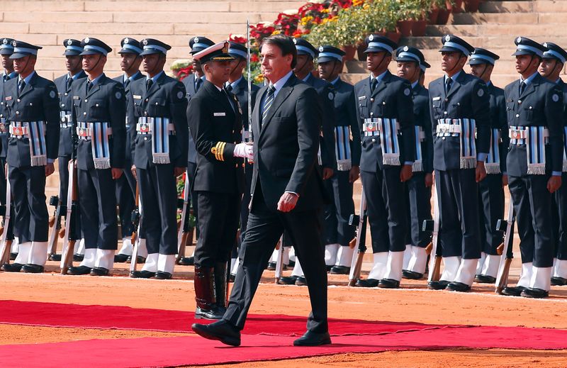 Brazil's President Jair Bolsonaro inspects an honour guard during his ceremonial reception at the forecourt of Rashtrapati Bhavan presidential palace in New Delhi