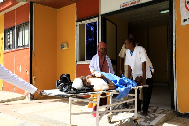Paramedics at the Madina hospital assist an unidentified man injured in an explosion in Afgoye, as he arrives for medical attention in Mogadishu