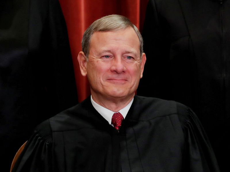 U.S. Supreme Court Chief Justice John Roberts poses during group portrait at the Supreme Court in Washington