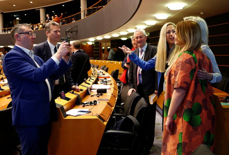 British members of the chamber pose for a photograph during their last plenary session at the European Parliament in Brussels