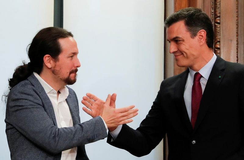 FILE PHOTO: Spain's acting PM Sanchez and Unidas Podemos leader Iglesias present their coalition agreement in Madrid