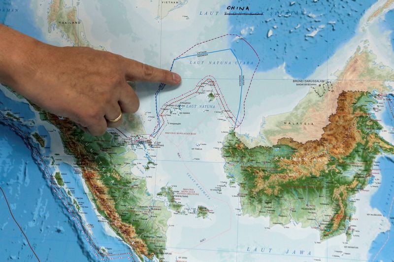 FILE PHOTO: Indonesia's Deputy Minister for Maritime Affairs Arif Havas Oegroseno points at the location of North Natuna Sea on a new map of Indonesia during talks with reporters in Jakarta