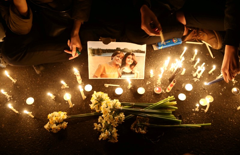 FILE PHOTO: People and families of the victims of the crash of the Boeing 737-800 plane, flight PS 752, light candles as they gather to show their sympathy in Tehran