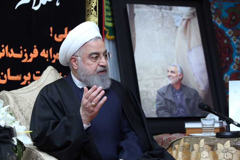 FILE PHOTO: Iranian President Hassan Rouhani visits the family of the Iranian Major-General Qassem Soleimani, head of the elite Quds Force, who was killed by an air strike in Baghdad, at his home in Tehran