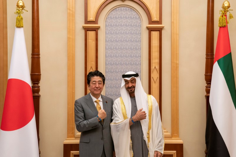 Abu Dhabi's Crown Prince Sheikh Mohammed bin Zayed al-Nahyan gestures with Japanese Prime Minister Shinzo Abe during a meeting in Abu Dhabi