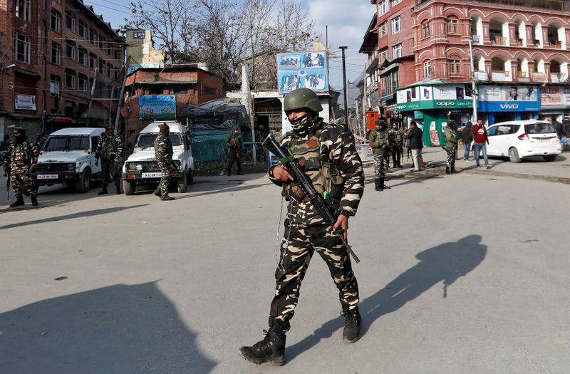 FILE PHOTO: Indian security forces personnel patrol a street in Srinagar