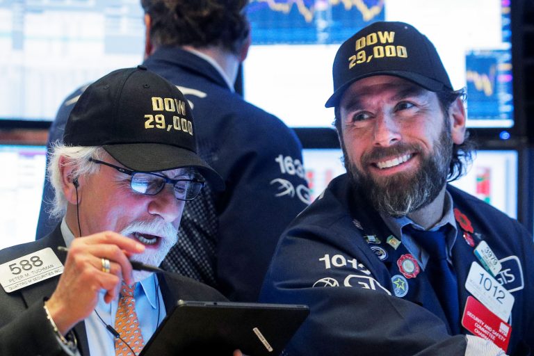 Stocks rise slightly to end a record-setting week