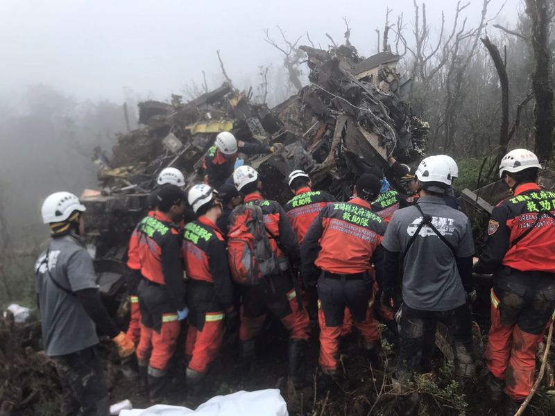 A rescue team searches for missing military officers, after a Black Hawk helicopter made a forced landing at a mountainous area near Taipei