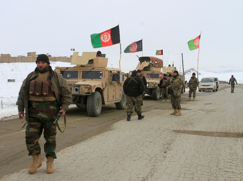 FILE PHOTO: Afghan National Army forces go towards the site of an airplane crash in Deh Yak district of Ghazni province