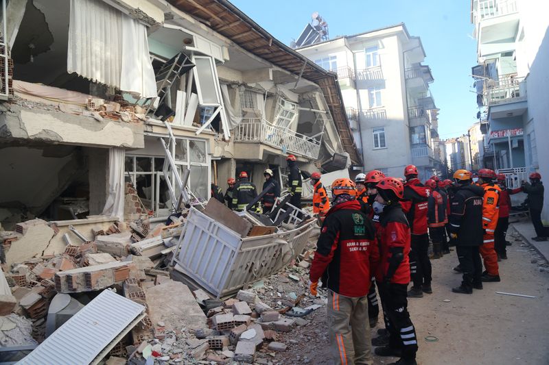 Rescuers work on a damaged building after an earthquake in Elazig