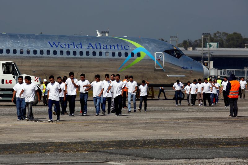 FILE PHOTO: Guatemalan migrants walk on the tarmac after being deported from U.S., at La Aurora International airport in Guatemala City