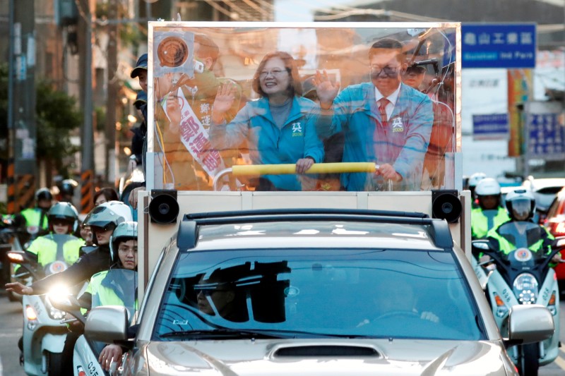 Taiwan President Tsai Ing-wen waves to supporters from a vehicle during a campaign rally ahead of the election in Taoyuan