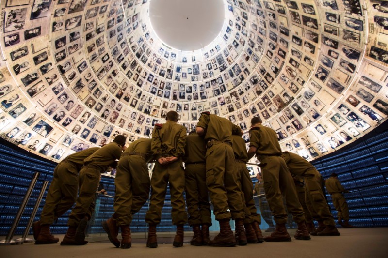 FILE PHOTO: Israeli soldiers stand under pictures of Jews killed in the Holocaust during a visit to the Yad Vashem Holocaust History Museum in Jerusalem
