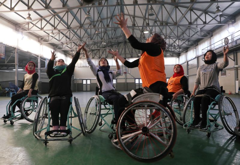 Disabled Afghan women play basketball at the Orthopaedic Center of the International Committee of the Red Cross in Kabul