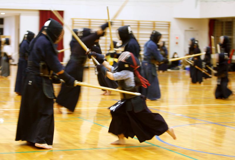 Children practice kendo with their teacher at the gymnasium of a primary school in Fukuoka