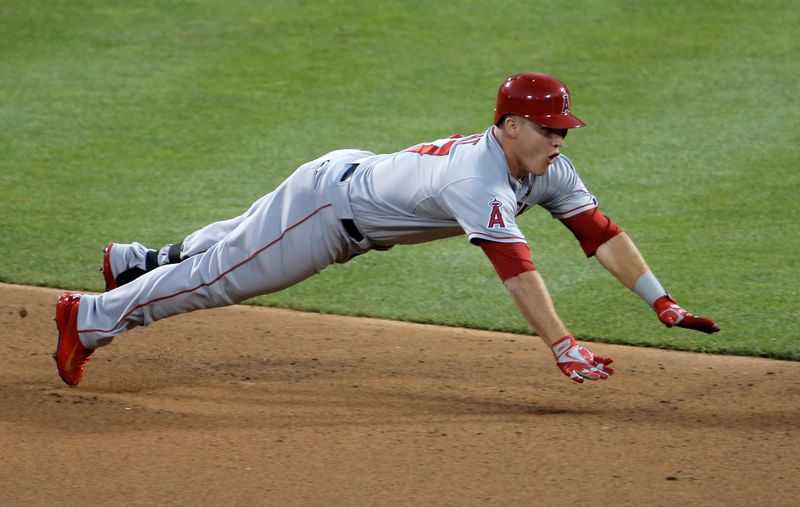 The American League's Mike Trout, of the Los Angeles Angels, dives into second base for a lead-off double in the first inning against the National League during Major League Baseball's All-Star Game in New York