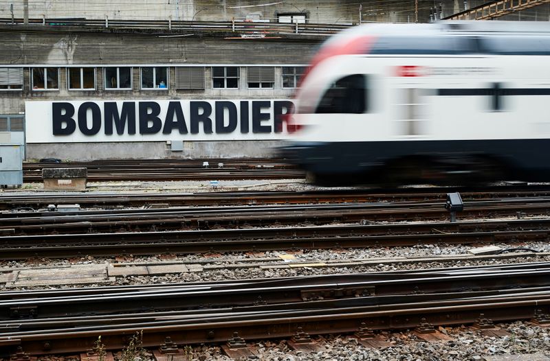 A Bombardier advertising board is pictured in front of a SBB CFF Swiss railway train at the station in Bern