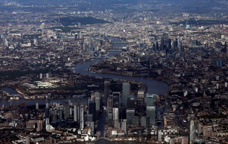 FILE PHOTO: Canary Wharf and the City of London financial district are seen from an aerial view in London