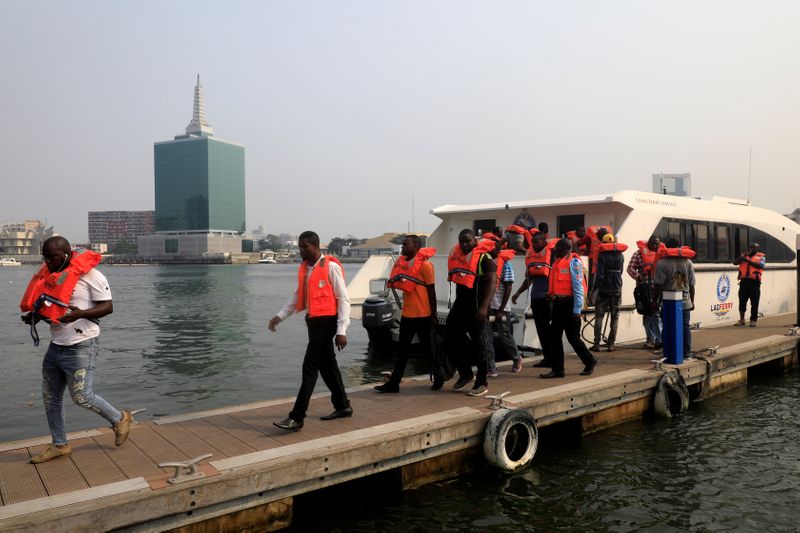 Passengers alight from a boat after arriving at Five Cowries Terminal in Falomo Lagos
