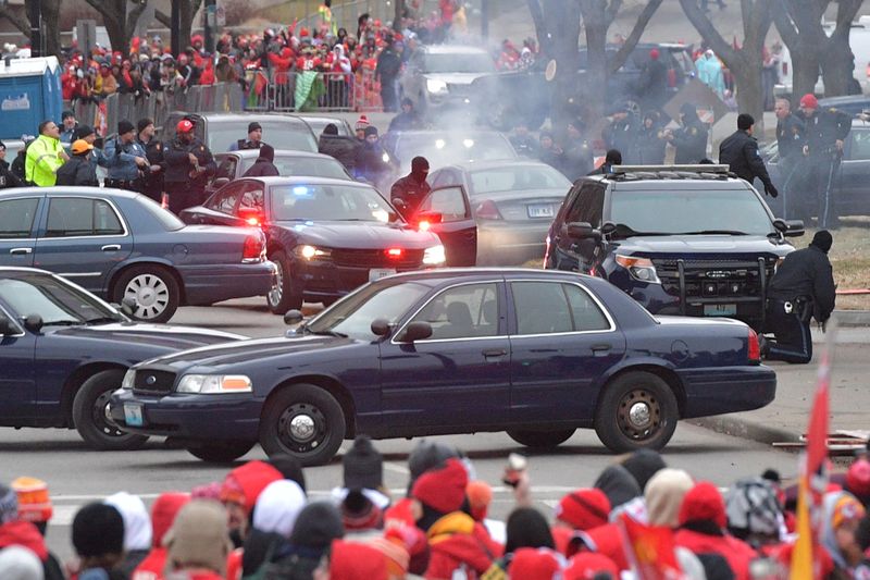 Police stop a car that was driven into the parade route before the Kansas City Chiefs Champions Parade in Kansas City