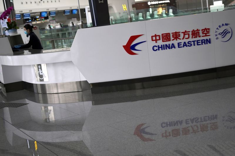 Staff member wearing a face mask is seen at a counter for China Eastern airlines at the Beijing Daxing International Airport, as the country is hit by an outbreak of the novel coronavirus, in Beijing
